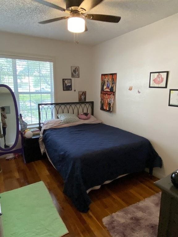 bedroom with wood finished floors and a ceiling fan