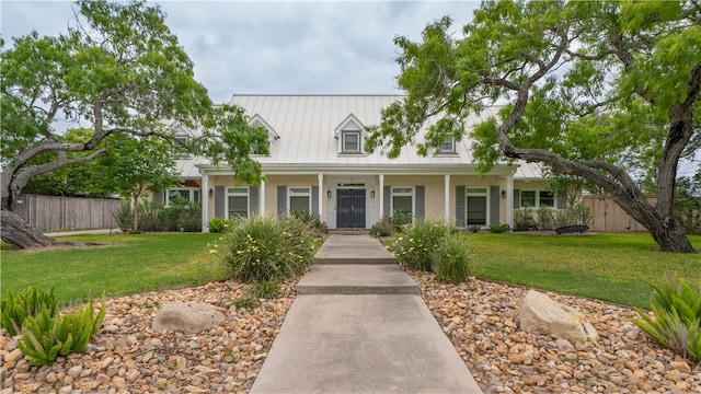 view of front of home with a porch and a front lawn