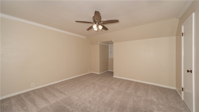 carpeted empty room featuring lofted ceiling, ceiling fan, and crown molding