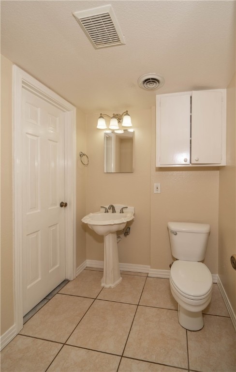 bathroom featuring toilet and tile patterned floors