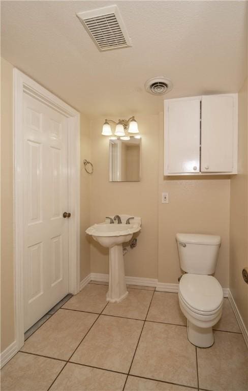 110 Amistad St, Corpus Christi, TX 78404 - bathroom with baseboards, tile patterned flooring, and toilet