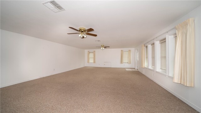 unfurnished room with light colored carpet and ceiling fan