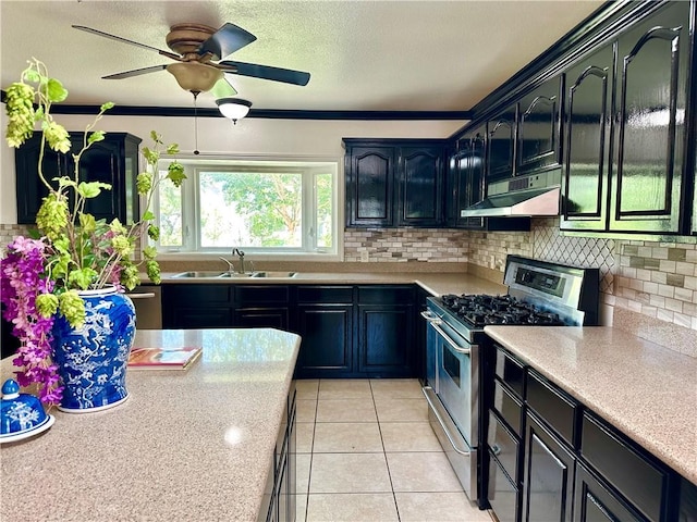 110 Amistad St, Corpus Christi, TX 78404 - kitchen featuring stainless steel range with gas stovetop, a sink, under cabinet range hood, and light countertops