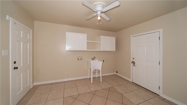 laundry room with cabinets, light tile patterned floors, and ceiling fan