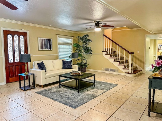 110 Amistad St, Corpus Christi, TX 78404 - living room featuring ceiling fan, a textured ceiling, stairway, crown molding, and light tile patterned flooring