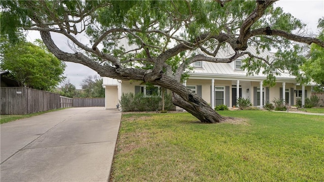 110 Amistad St, Corpus Christi, TX 78404 - view of front facade featuring concrete driveway, a standing seam roof, and metal roof