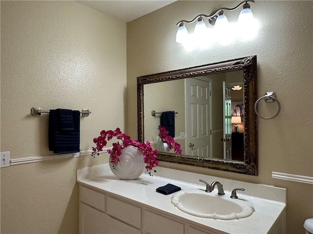 110 Amistad St, Corpus Christi, TX 78404 - bathroom with vanity, a textured wall, and toilet
