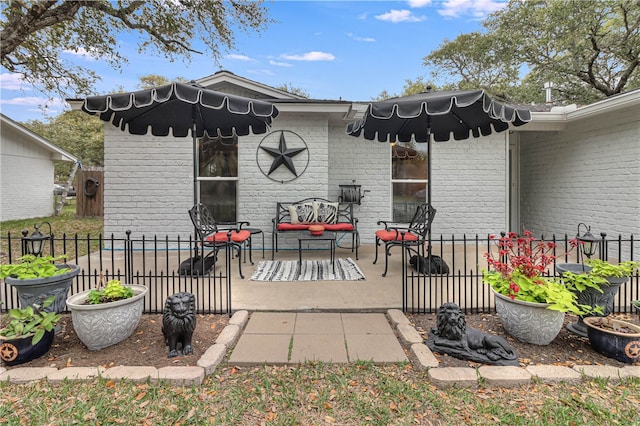 rear view of property featuring a patio