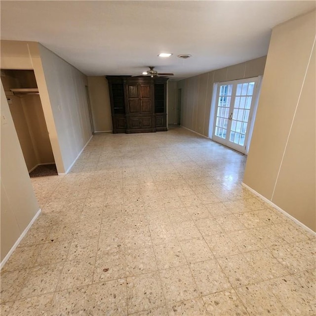 unfurnished living room featuring ceiling fan, baseboards, and tile patterned floors