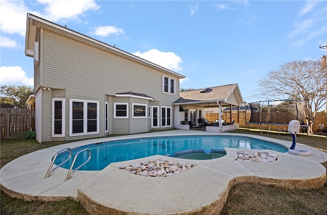 view of pool featuring a trampoline and a patio