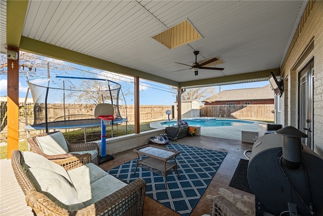 view of patio / terrace with a fenced in pool and a trampoline