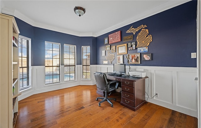 home office with hardwood / wood-style flooring and crown molding