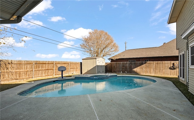 view of swimming pool with an in ground hot tub, a patio, and a storage unit