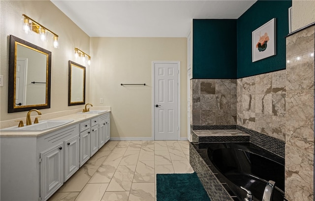 bathroom with vanity and tiled tub