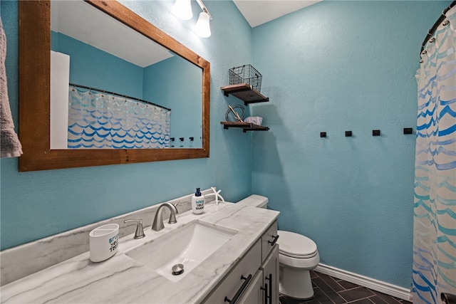 bathroom with vanity, toilet, and tile patterned flooring