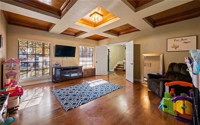 living room with hardwood / wood-style floors, ornamental molding, coffered ceiling, wooden ceiling, and beam ceiling