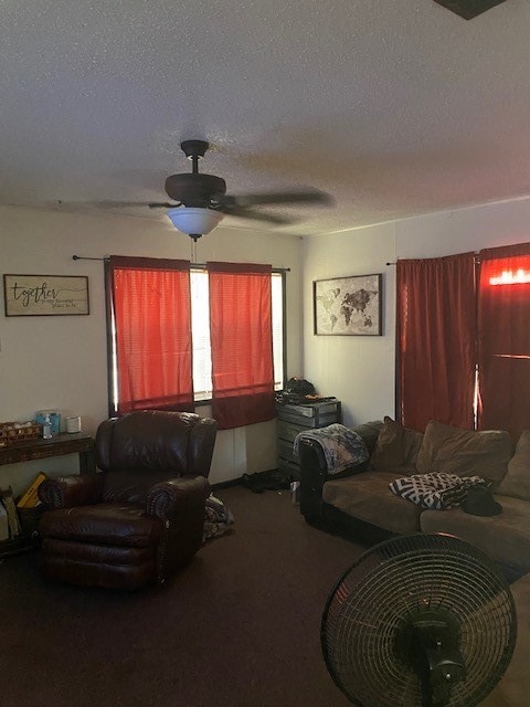 living room with a textured ceiling, carpet, and ceiling fan