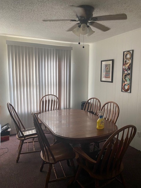 dining area with ceiling fan, a textured ceiling, and carpet flooring