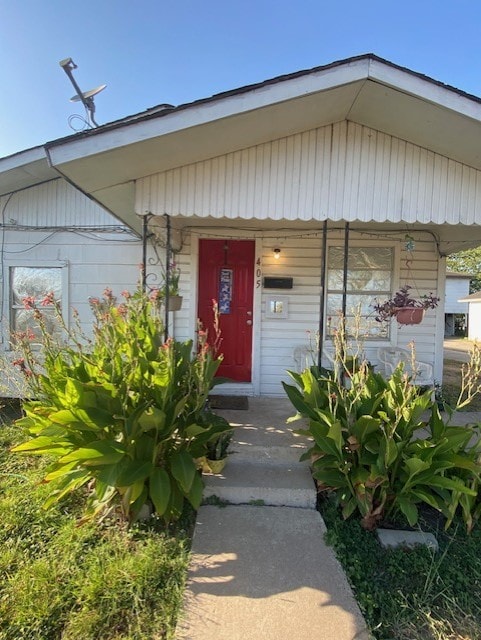 view of exterior entry with a porch