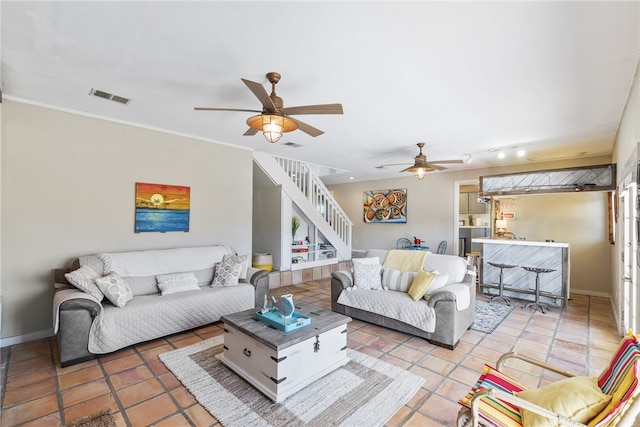 living room with tile patterned flooring, ceiling fan, and track lighting