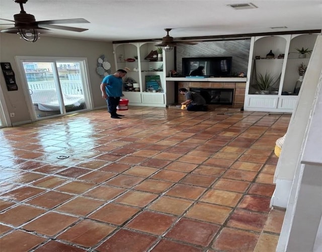 13525 Bullion Ct, Corpus Christi, TX 78418 - unfurnished living room featuring a ceiling fan, a large fireplace, and tile patterned flooring