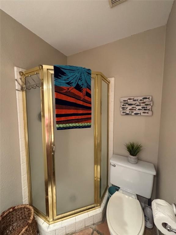 13525 Bullion Ct, Corpus Christi, TX 78418 - full bathroom with a shower stall and vaulted ceiling