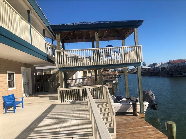 exterior space featuring a deck with water view