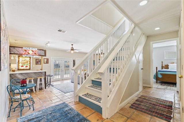 stairs featuring ceiling fan, french doors, and tile patterned flooring