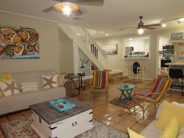 13525 Bullion Ct, Corpus Christi, TX 78418 - living area with ceiling fan, stairway, light tile patterned flooring, and crown molding