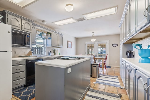 kitchen featuring dishwasher, a center island, white refrigerator, gray cabinets, and built in microwave