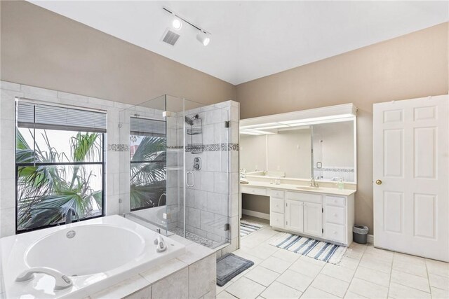 bathroom with independent shower and bath, tile patterned flooring, and vanity