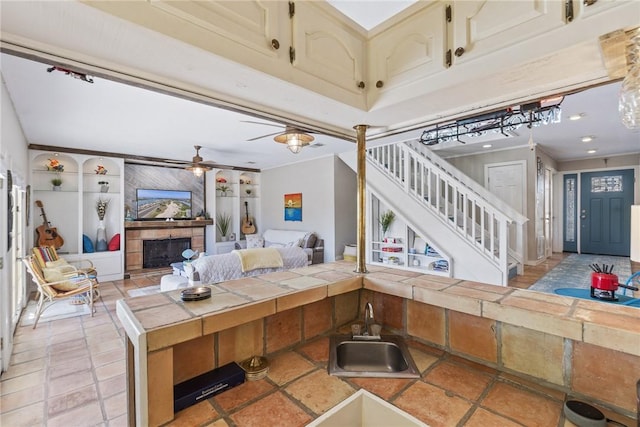 13525 Bullion Ct, Corpus Christi, TX 78418 - living area with stairs, ceiling fan, a fireplace, and built in features