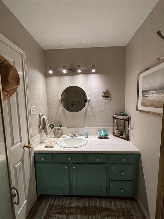 13525 Bullion Ct, Corpus Christi, TX 78418 - bathroom featuring vanity and wood finished floors
