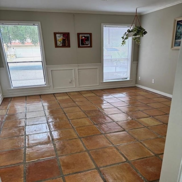 13525 Bullion Ct, Corpus Christi, TX 78418 - unfurnished dining area featuring crown molding, tile patterned floors, and wainscoting