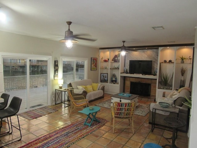 13525 Bullion Ct, Corpus Christi, TX 78418 - living room featuring ceiling fan and a tile fireplace