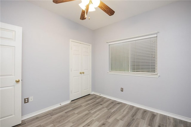 6513 Purplewing Dr, Corpus Christi, TX 78414 - unfurnished bedroom featuring light wood-style floors, baseboards, ceiling fan, and a closet