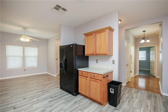 6513 Purplewing Dr, Corpus Christi, TX 78414 - kitchen with black fridge, light wood finished floors, light countertops, baseboards, and ceiling fan