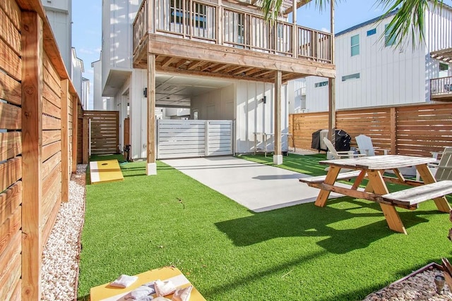 view of yard with a patio area and a wooden deck