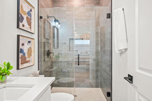 bathroom featuring walk in shower, vanity, and toilet