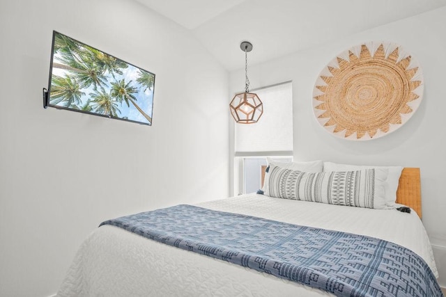 bedroom with lofted ceiling