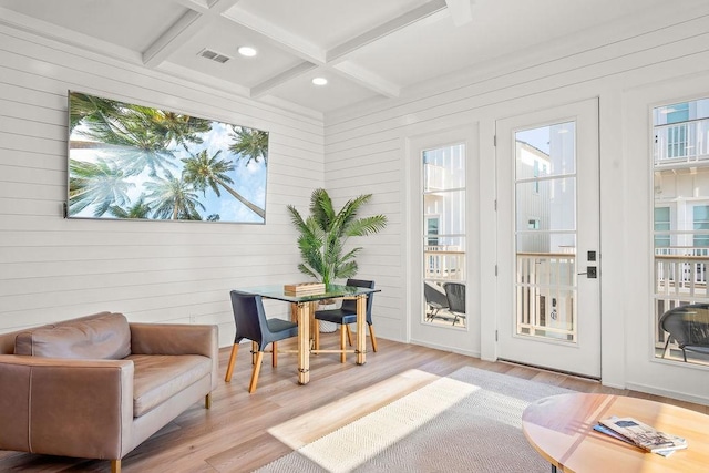 entryway with beamed ceiling, wooden walls, light hardwood / wood-style floors, and coffered ceiling