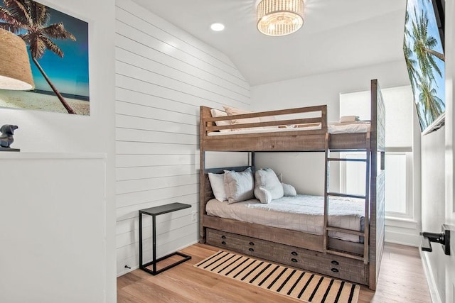 bedroom with lofted ceiling and light wood-type flooring