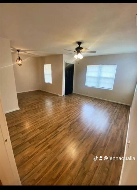 spare room featuring dark hardwood / wood-style floors and ceiling fan