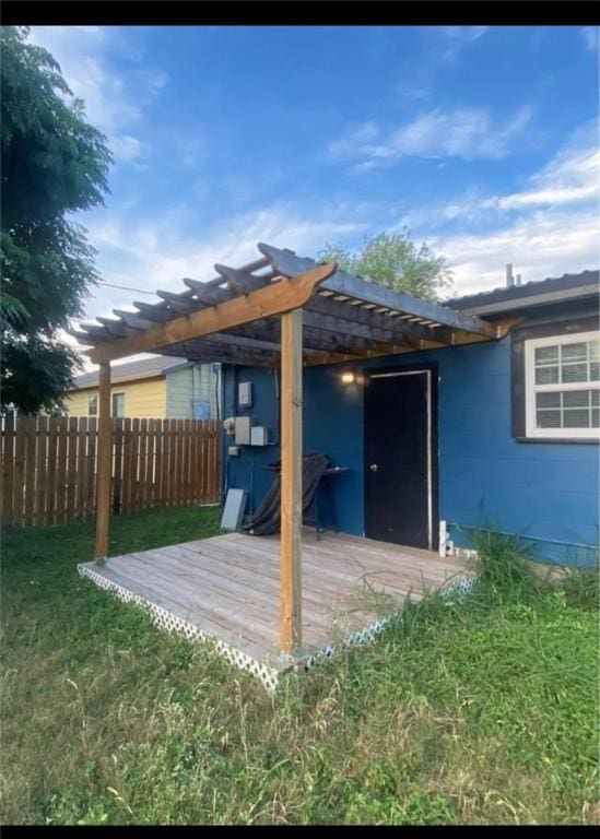 deck with a yard and a pergola