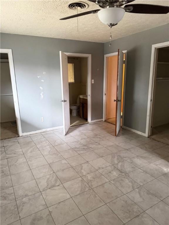 unfurnished bedroom with ceiling fan, a closet, and a textured ceiling