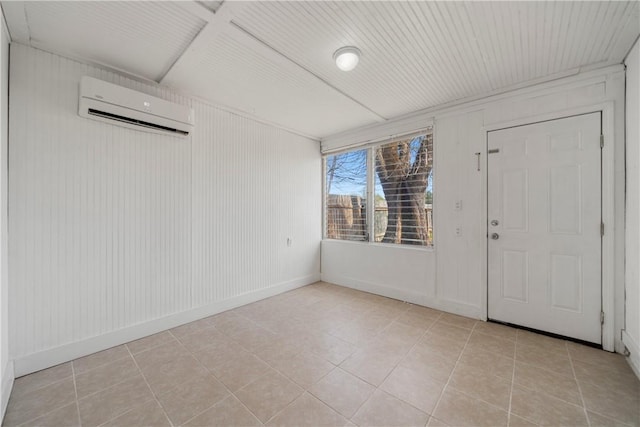 interior space featuring a wall mounted air conditioner, baseboards, and light tile patterned floors