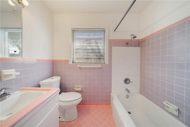 bathroom with shower / bath combination, plenty of natural light, tile walls, and tile patterned floors