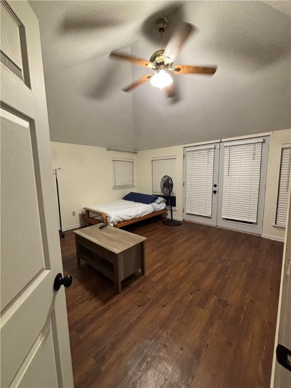 bedroom featuring ceiling fan, lofted ceiling, and dark hardwood / wood-style flooring