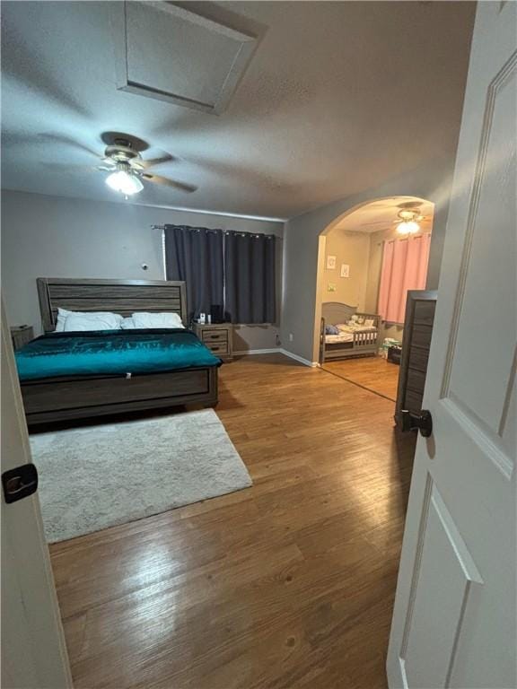 bedroom featuring wood-type flooring and ceiling fan