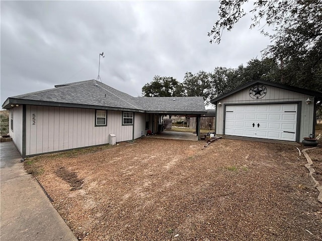 view of front of house featuring a garage, an outdoor structure, and a carport